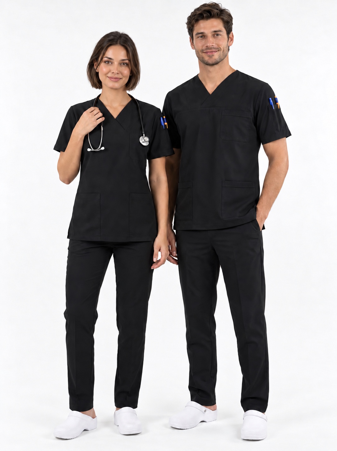 Woman and man wearing coordinated black medical scrub sets